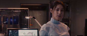 Movie still from “Avengers: Age of Ultron” (2015), directed by Joss Whedon – A woman standing in front of a computer monitor; Close Up shot, Over the shoulder angle