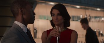 Movie still from “Avengers: Age of Ultron” (2015), directed by Joss Whedon – A woman in a red dress holding a wine glass; Close Up shot, Over the shoulder angle