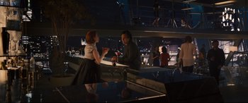 Movie still from “Avengers: Age of Ultron” (2015), directed by Joss Whedon – A man and a woman are having a conversation at a bar; Wide shot, High angle