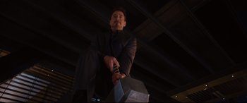 Movie still from “Avengers: Age of Ultron” (2015), directed by Joss Whedon – A man in a black suit holding a hammer in his hand; Medium shot, Low angle