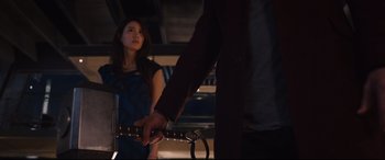 Movie still from “Avengers: Age of Ultron” (2015), directed by Joss Whedon – A woman holding a sword in front of a man in a dark room; Medium shot, Over the shoulder angle