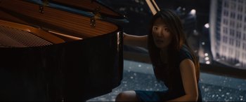 Movie still from “Avengers: Age of Ultron” (2015), directed by Joss Whedon – A woman sitting in front of an open piano; Medium shot, High angle