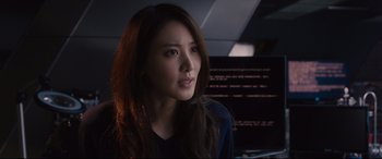 Movie still from “Avengers: Age of Ultron” (2015), directed by Joss Whedon – A beautiful young woman with long brown hair and blue eyes; Close Up shot, Over the shoulder angle