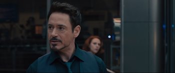 Movie still from “Avengers: Age of Ultron” (2015), directed by Joss Whedon – A person wearing a shirt and tie; Close Up shot, Over the shoulder angle