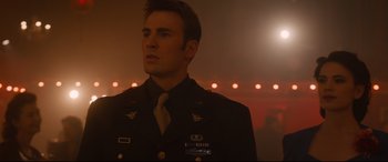 Movie still from “Avengers: Age of Ultron” (2015), directed by Joss Whedon – A man in a military uniform standing in front of lights; Medium shot, Low angle