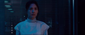 Movie still from “Avengers: Age of Ultron” (2015), directed by Joss Whedon – A woman in a white shirt is standing in a room; Close Up shot, Low angle