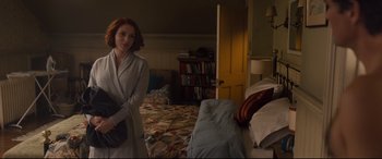 Movie still from “Avengers: Age of Ultron” (2015), directed by Joss Whedon – A woman standing in front of a bed in a bedroom; Wide shot, Over the shoulder angle