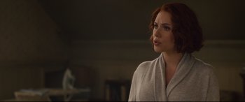 Movie still from “Avengers: Age of Ultron” (2015), directed by Joss Whedon – A woman with red hair is standing in a room; Medium shot, Over the shoulder angle
