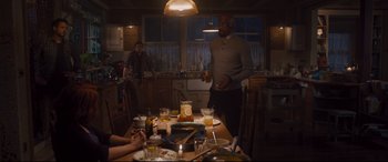 Movie still from “Avengers: Age of Ultron” (2015), directed by Joss Whedon – A group of people sitting around a table in a kitchen; Wide shot, Over the shoulder angle