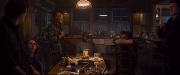 Movie still from “Avengers: Age of Ultron” (2015), directed by Joss Whedon – A group of people sitting at a table in a kitchen; Medium shot, High angle