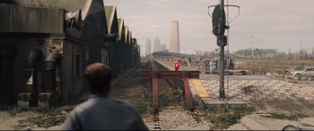 Movie still from “Avengers: Age of Ultron” (2015), directed by Joss Whedon – A man standing on the side of a train track next to train tracks; Extreme Wide shot, High angle
