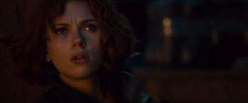 Movie still from “Avengers: Age of Ultron” (2015), directed by Joss Whedon – A person with short curly hair; Close Up shot, Over the shoulder angle