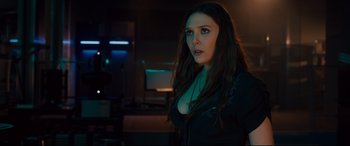 Movie still from “Avengers: Age of Ultron” (2015), directed by Joss Whedon – A woman with long dark hair standing in a dark room; Close Up shot, Over the shoulder angle