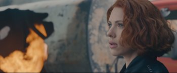 Movie still from “Avengers: Age of Ultron” (2015), directed by Joss Whedon – A person with red hair looking at something; Close Up shot, Over the shoulder angle