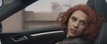 Movie still from “Avengers: Age of Ultron” (2015), directed by Joss Whedon – A person sitting in a car; Close Up shot, Over the shoulder angle