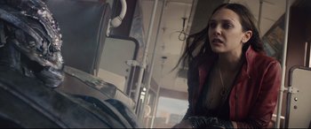Movie still from “Avengers: Age of Ultron” (2015), directed by Joss Whedon – A woman sitting on a bus listening to music; Medium shot, Low angle