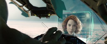 Movie still from “Avengers: Age of Ultron” (2015), directed by Joss Whedon – A woman is looking at the camera from a cockpit; Close Up shot, Over the shoulder angle