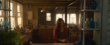 Movie still from “Avengers: Age of Ultron” (2015), directed by Joss Whedon – A woman standing in a kitchen next to a counter; Medium shot, Low angle