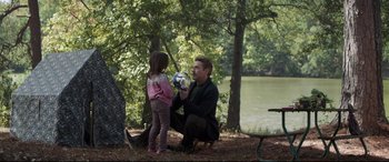 Movie still from “Avengers: Endgame” (2019), directed by Anthony Russo – A man and a little girl are playing with a ball in the woods; Wide shot, Over the shoulder angle