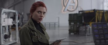 Movie still from “Avengers: Endgame” (2019), directed by Anthony Russo – A woman with red hair is holding a tablet; Close Up shot, Over the shoulder angle