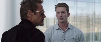 Movie still from “Avengers: Endgame” (2019), directed by Anthony Russo – A man standing next to another man in front of a building; Close Up shot, Over the shoulder angle