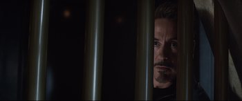 Movie still from “Avengers: Endgame” (2019), directed by Anthony Russo – A person looking through a fence; Close Up shot, Over the shoulder angle