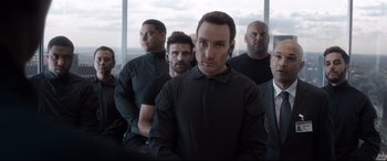 Movie still from “Avengers: Endgame” (2019), directed by Anthony Russo – A group of men standing next to each other in front of a window; Medium shot, Low angle