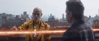 Movie still from “Avengers: Endgame” (2019), directed by Anthony Russo – A bald man in a yellow jacket talking to a man in a yellow jacket; Medium shot, Over the shoulder angle