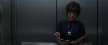 Movie still from “Avengers: Endgame” (2019), directed by Anthony Russo – A woman sitting on a train looking at a book; Close Up shot, Low angle