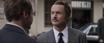 Movie still from “Avengers: Endgame” (2019), directed by Anthony Russo – A man in a gray suit and a tie; Close Up shot, Over the shoulder angle