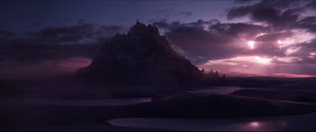 A purple sky with a mountain in the background