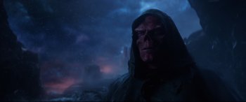 Movie still from “Avengers: Endgame” (2019), directed by Anthony Russo – A man with a red skull mask and a hooded jacket; Close Up shot, Over the shoulder angle