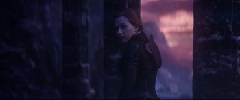 Movie still from “Avengers: Endgame” (2019), directed by Anthony Russo – A woman standing in front of a wall with trees in the background; Medium shot, Over the shoulder angle