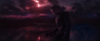 Movie still from “Avengers: Endgame” (2019), directed by Anthony Russo – A man sitting on the ground in the water at night; Medium shot, Low angle