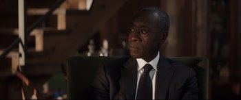 Movie still from “Avengers: Endgame” (2019), directed by Anthony Russo – A man wearing a suit and tie sitting in a chair; Close Up shot, Over the shoulder angle