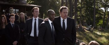 Movie still from “Avengers: Endgame” (2019), directed by Anthony Russo – A group of men standing next to each other in suits; Medium shot, Over the shoulder angle