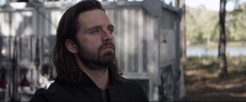 Movie still from “Avengers: Endgame” (2019), directed by Anthony Russo – A man with long hair and a beard is looking up; Close Up shot, Over the shoulder angle