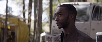 Movie still from “Avengers: Endgame” (2019), directed by Anthony Russo – A person wearing a jacket near a tree; Close Up shot, Over the shoulder angle