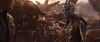 Movie still from “Avengers: Infinity War” (2018), directed by Anthony Russo – An image of a woman with a mask in the background; Close Up shot, Low angle