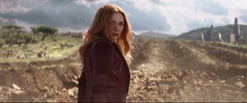 Movie still from “Avengers: Infinity War” (2018), directed by Anthony Russo – A woman with long red hair standing in a field; Medium shot, Low angle