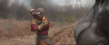 Movie still from “Avengers: Infinity War” (2018), directed by Anthony Russo – A man in a red and gold outfit holding a sword; Medium shot, Over the shoulder angle