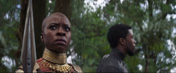 Movie still from “Avengers: Infinity War” (2018), directed by Anthony Russo – A woman in a gold necklace and a man in a black shirt; Close Up shot, Low angle