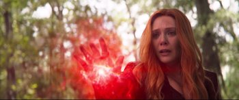 Movie still from “Avengers: Infinity War” (2018), directed by Anthony Russo – A woman with long red curly hair is holding a red hand; Medium shot, Low angle