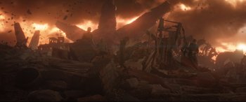 Movie still from “Avengers: Infinity War” (2018), directed by Anthony Russo – A man standing on a pile of rubble in the middle of the night; Extreme Wide shot, Low angle