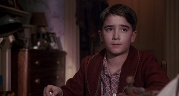 Movie still from “Awakenings” (1990), directed by Penny Marshall – A young boy sitting in front of a wooden dresser; Close Up shot, Over the shoulder angle
