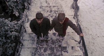 Movie still from “Awakenings” (1990), directed by Penny Marshall – Two young men standing on a set of steps; Medium shot, Overhead angle