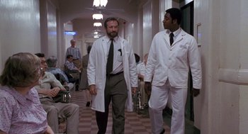 Movie still from “Awakenings” (1990), directed by Penny Marshall – Two men in white lab coats walking down a hall way; Wide shot, Low angle