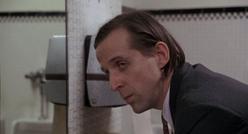 Movie still from “Awakenings” (1990), directed by Penny Marshall – A person wearing a suit and tie; Close Up shot, Low angle