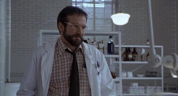 Movie still from “Awakenings” (1990), directed by Penny Marshall – A man wearing a lab coat and tie; Medium shot, Over the shoulder angle