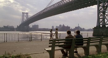 Movie still from “Awakenings” (1990), directed by Penny Marshall – A group of people sitting on top of a wooden bench; Extreme Wide shot, Over the shoulder angle